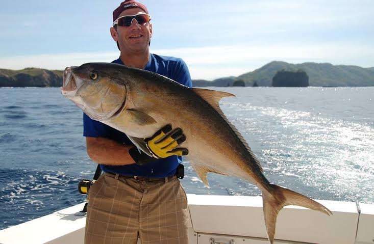 Angler holding a jack crevalle caught in Costa Rica