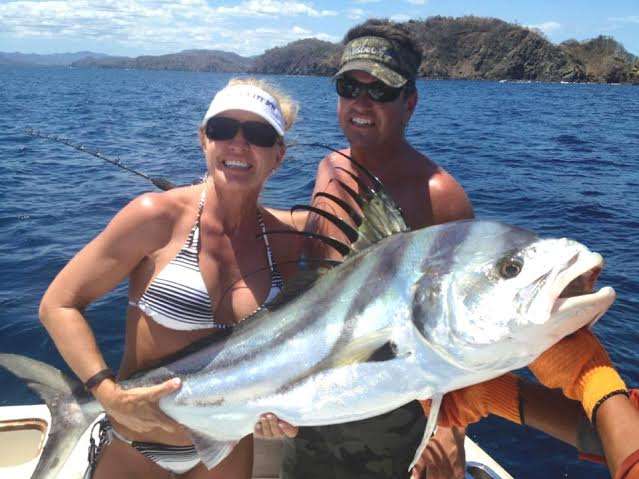 Couple with large roosterfish in Costa Rica