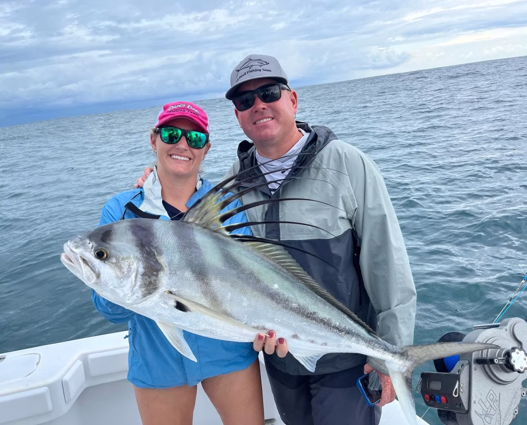 Couple holding a roosterfish in Costa Rica