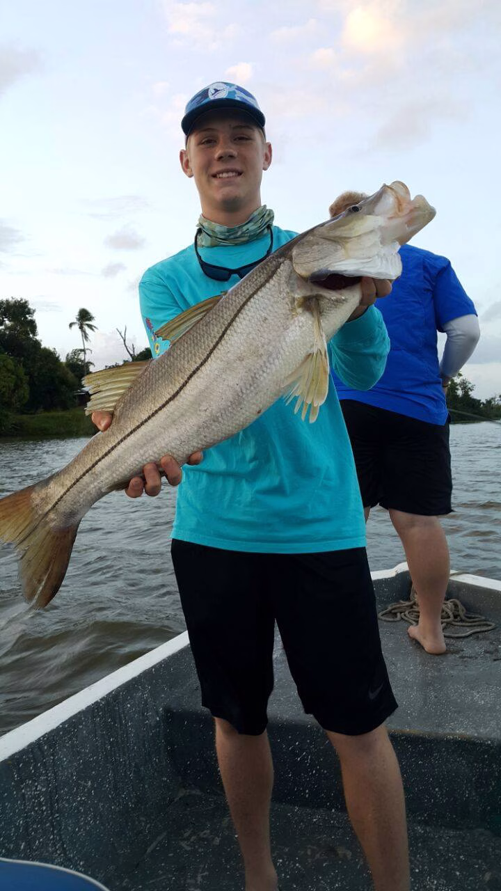 Young angler holding snook in Costa Rica